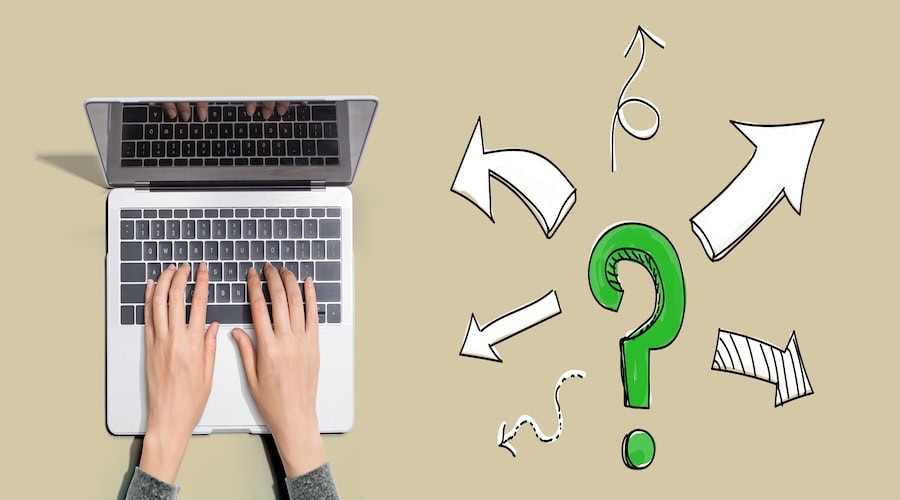 Question mark with arrows with person using laptop computer