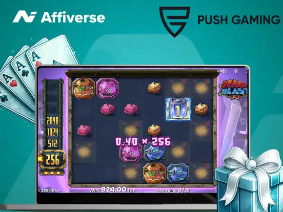Push Gaming slot game on a laptop with casino cards and bonus visuals