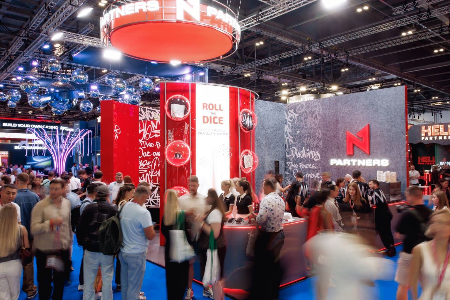 Attendees visiting and interacting with the N1 Partners exhibition booth at iGB L!VE 2026